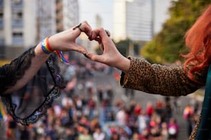 two women holding hands with a crowd of people in the background