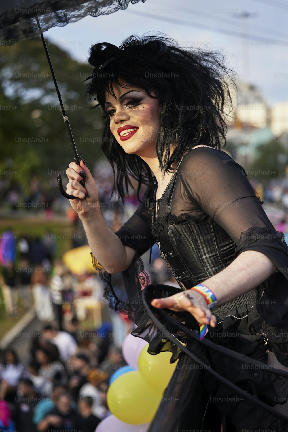 a woman in a black dress holding an umbrella