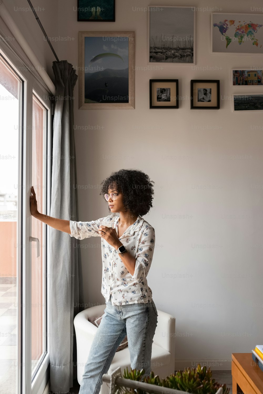 a woman standing in front of a window