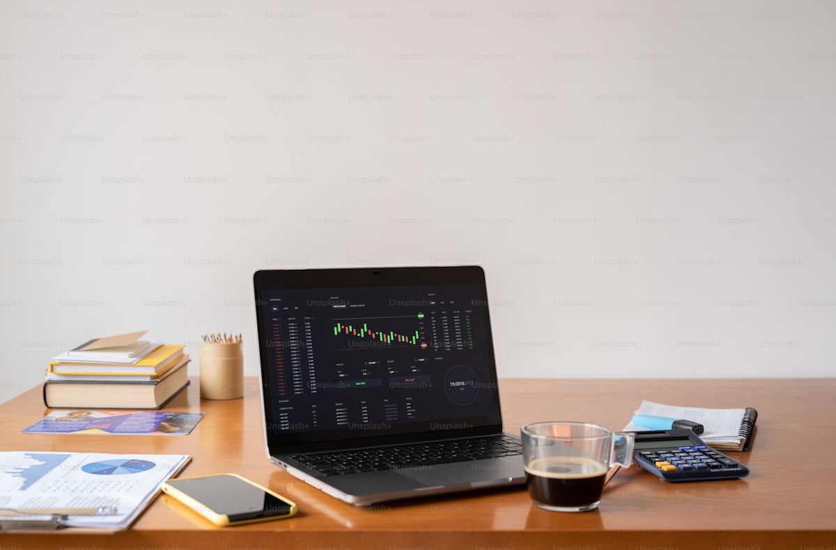 Desk setup with notebook and laptop for building a portfolio
