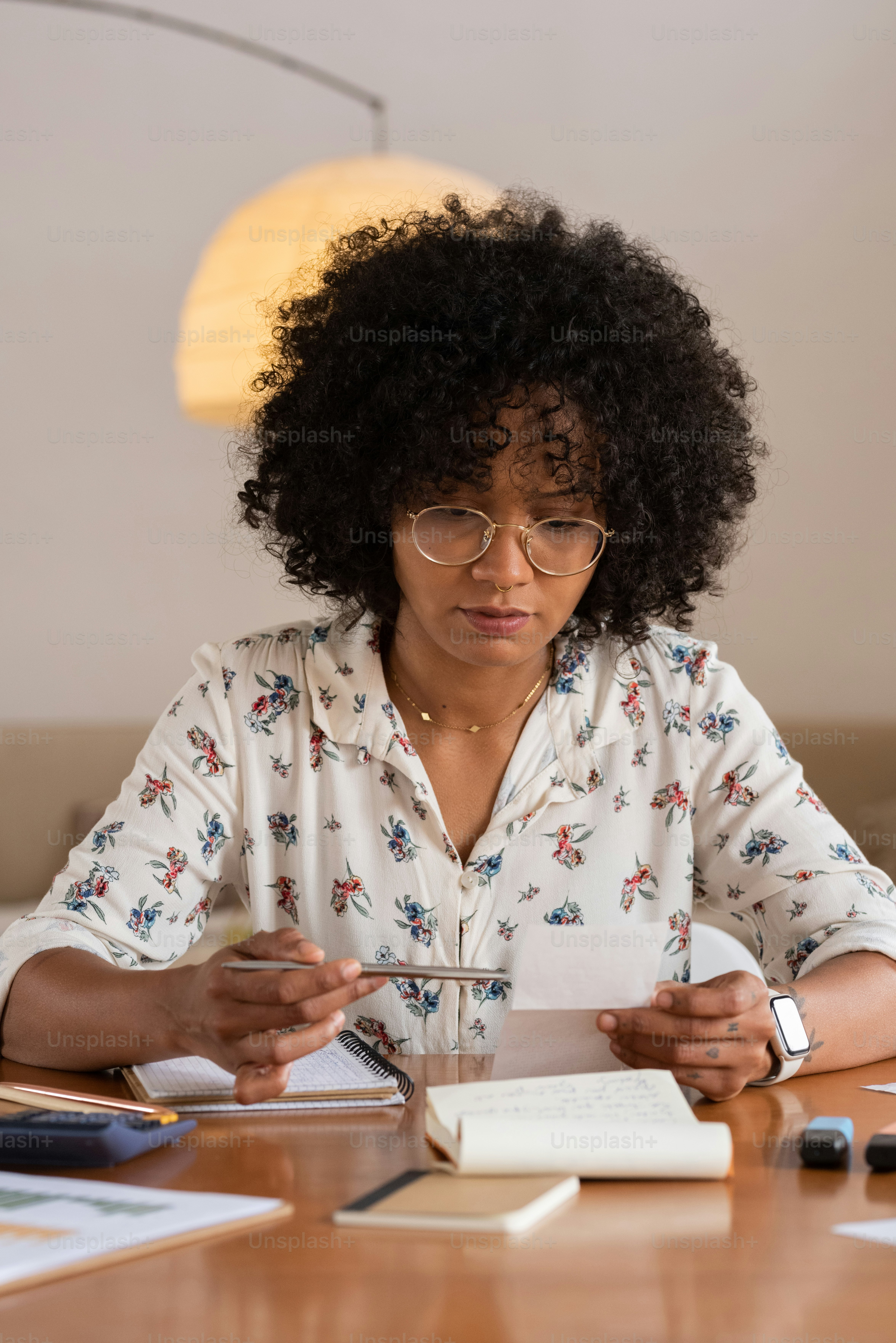 a woman sitting at a table with a piece of paper