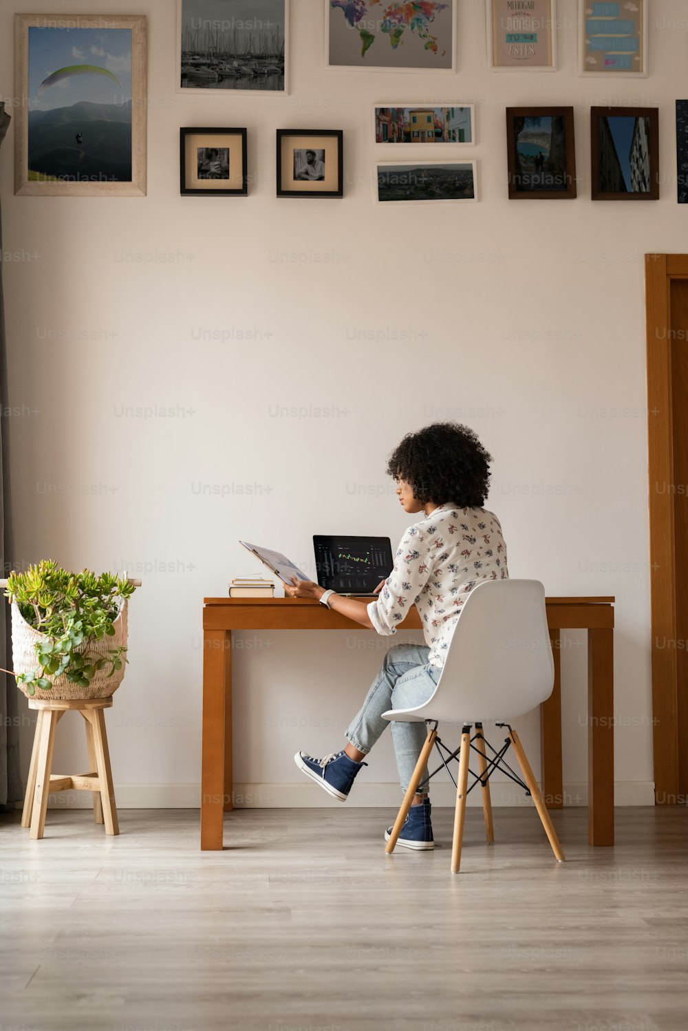 a woman sitting at a desk with a laptop