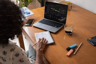 a woman sitting at a desk with a laptop and calculator