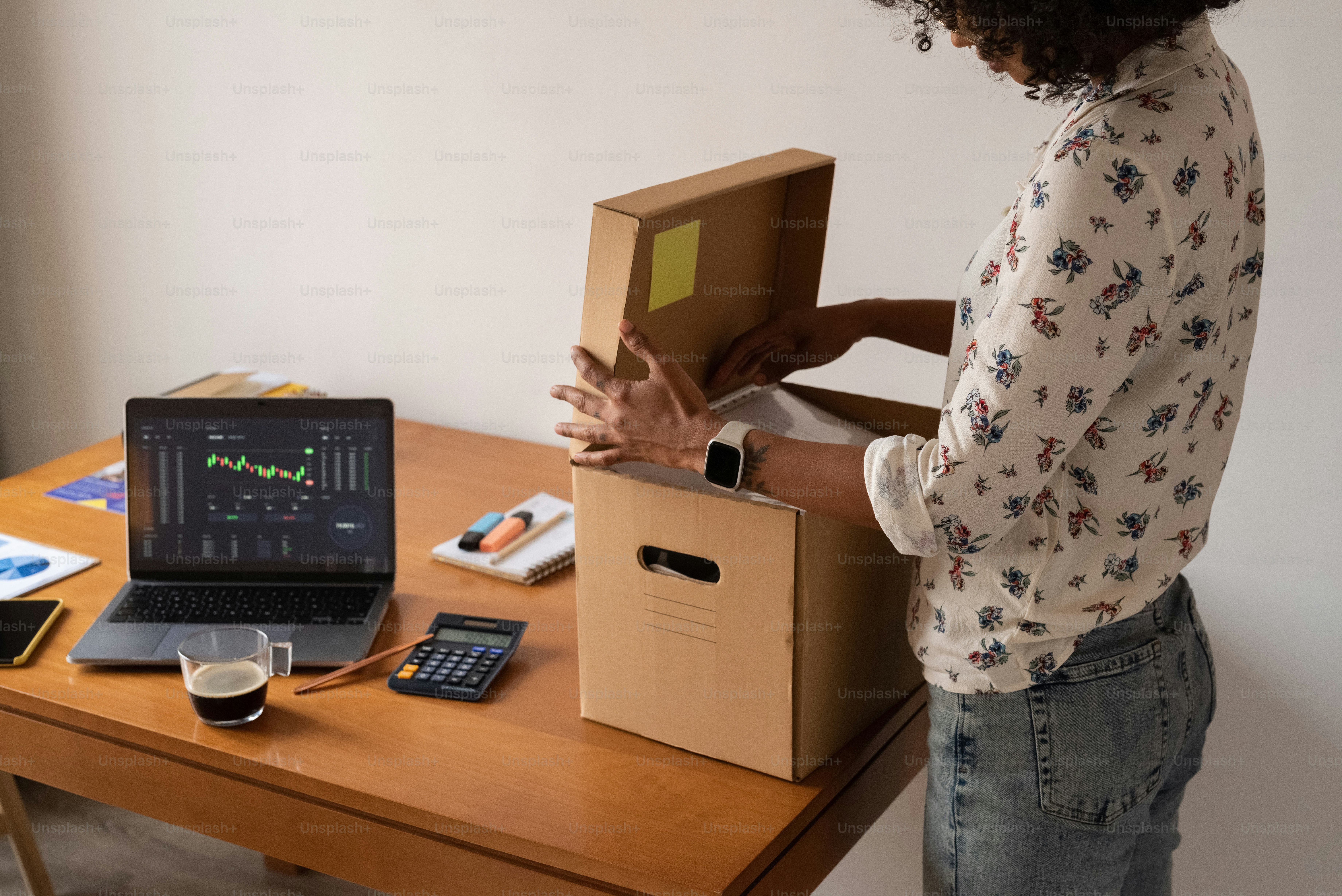 a woman standing in front of a laptop computer