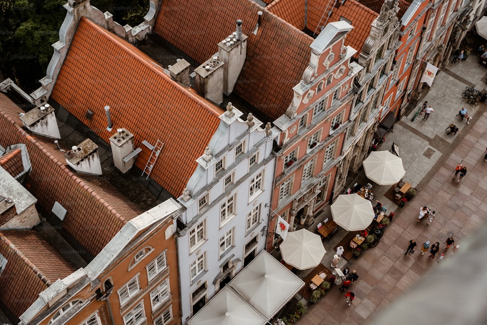 an aerial view of a city with buildings and umbrellas