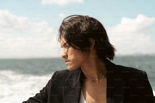 a woman standing on a beach next to the ocean