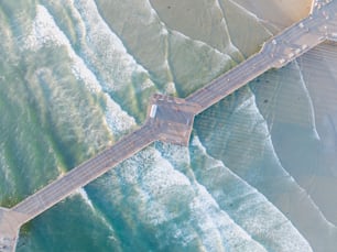 an aerial view of a bridge over a body of water