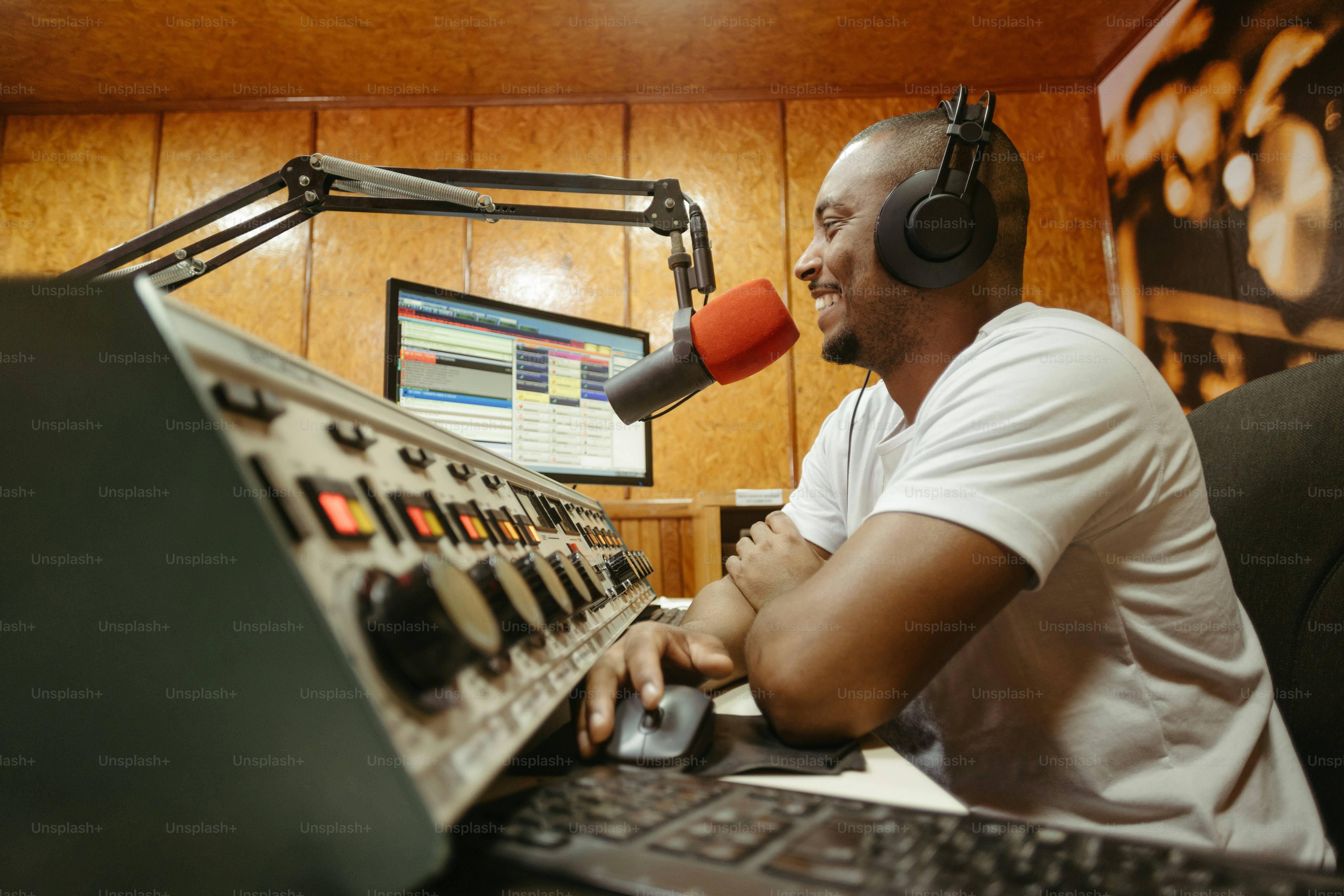 a man sitting in front of a computer with headphones on