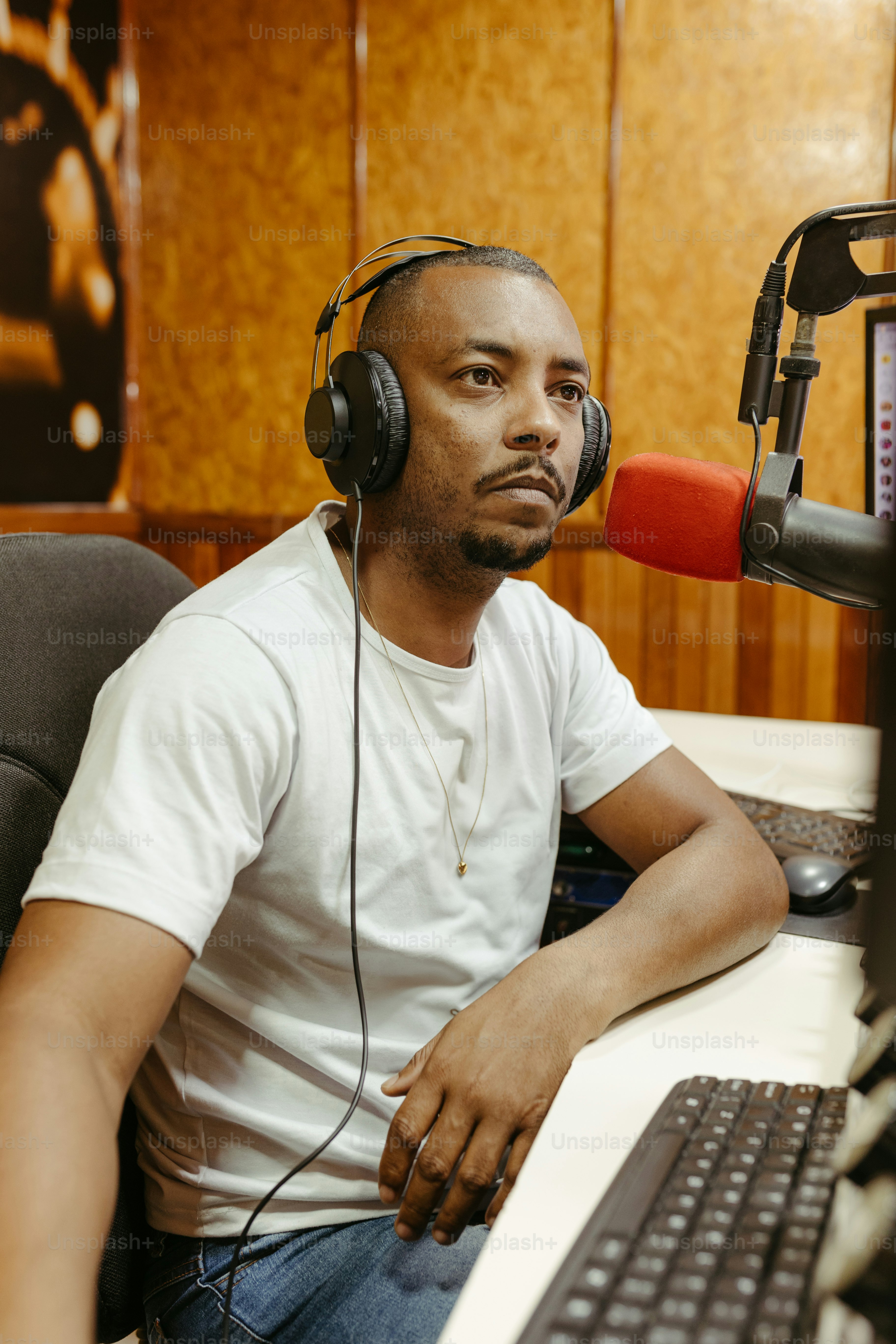 a man wearing headphones sitting in front of a computer