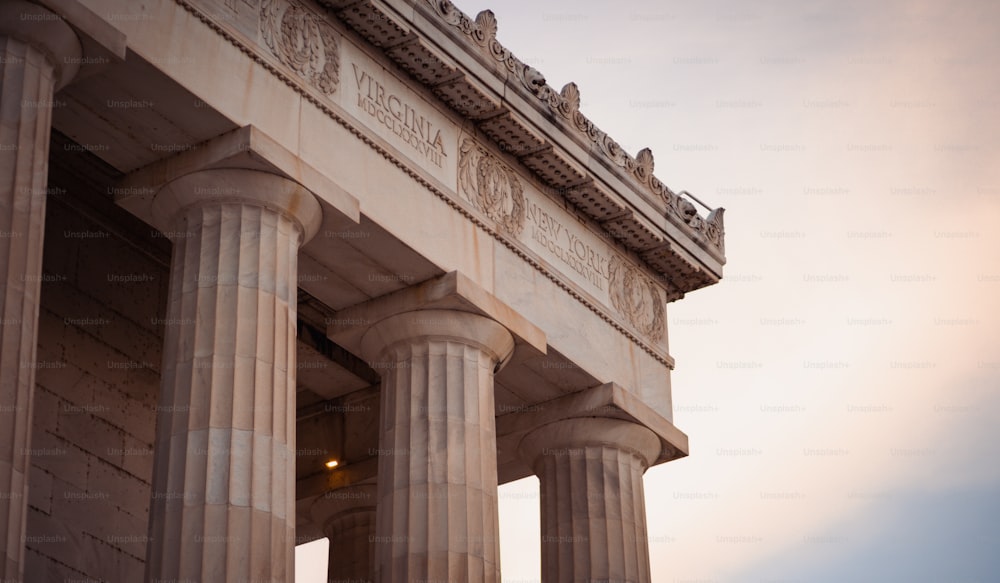 a close up of the top of a building with columns