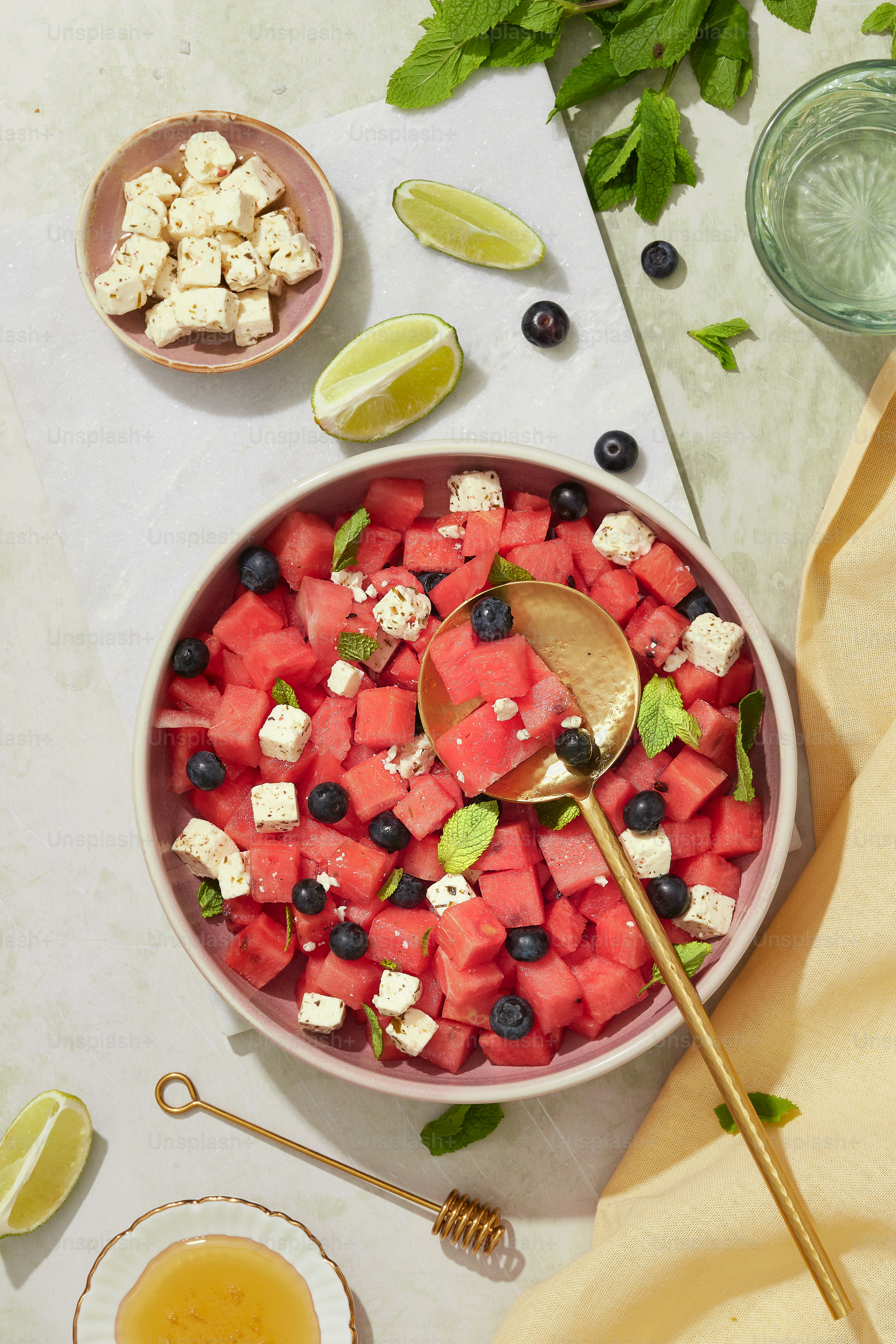 a bowl of watermelon, blueberries, and feta cheese