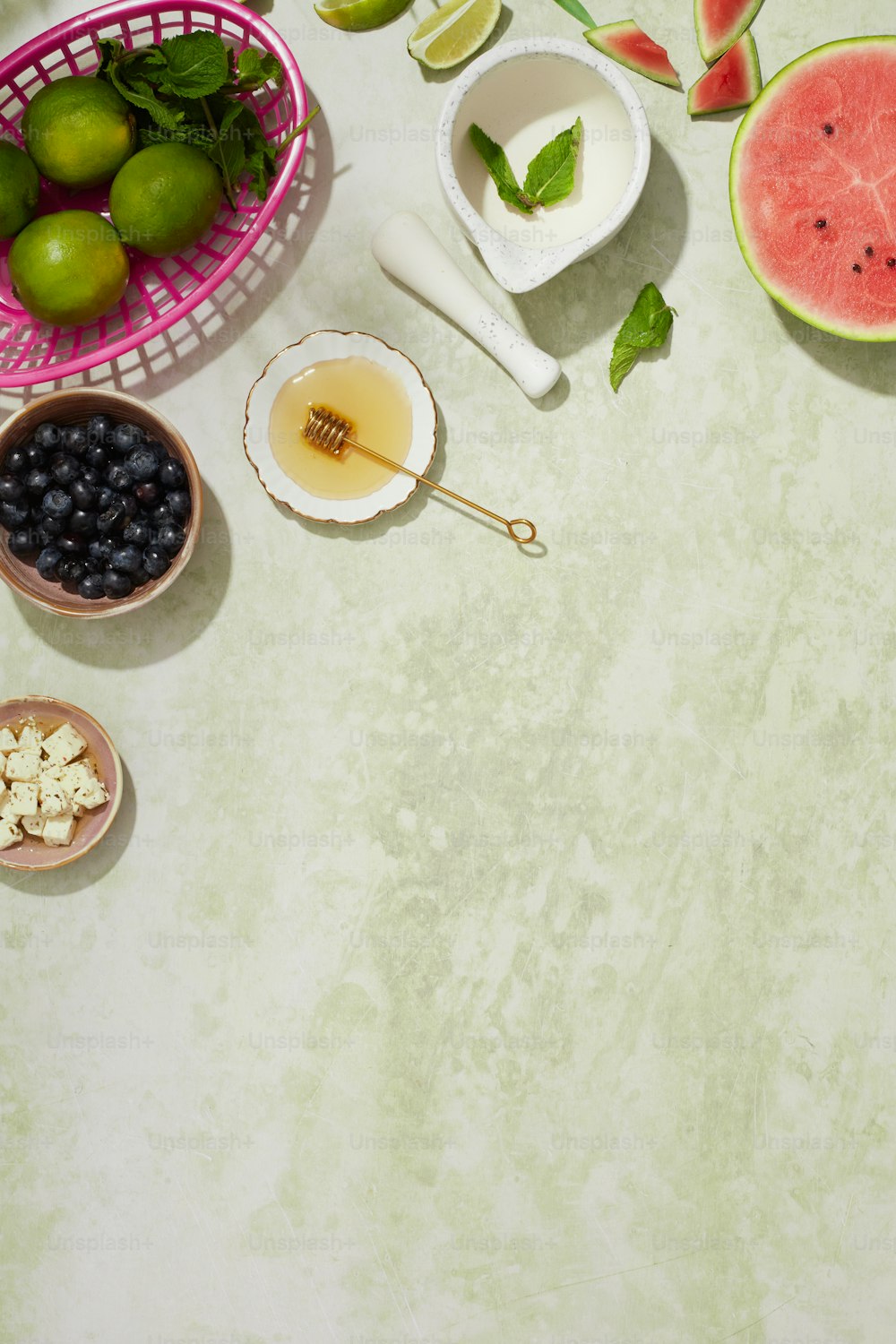 a table topped with bowls of fruit and a bowl of fruit