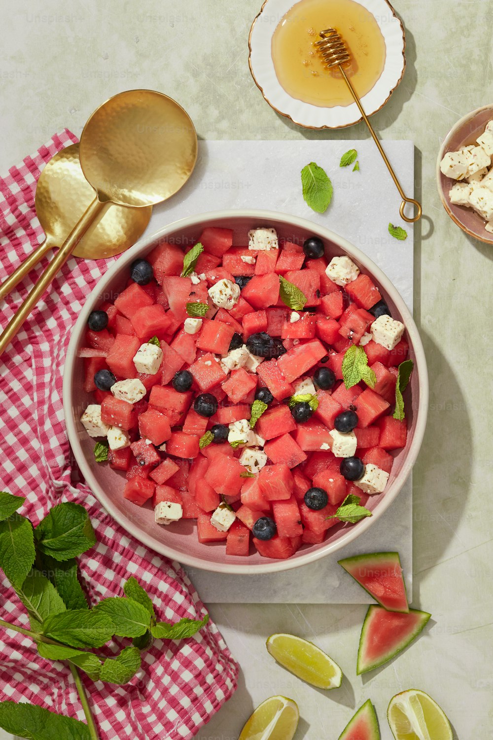 a bowl of watermelon, blueberries, and feta cheese