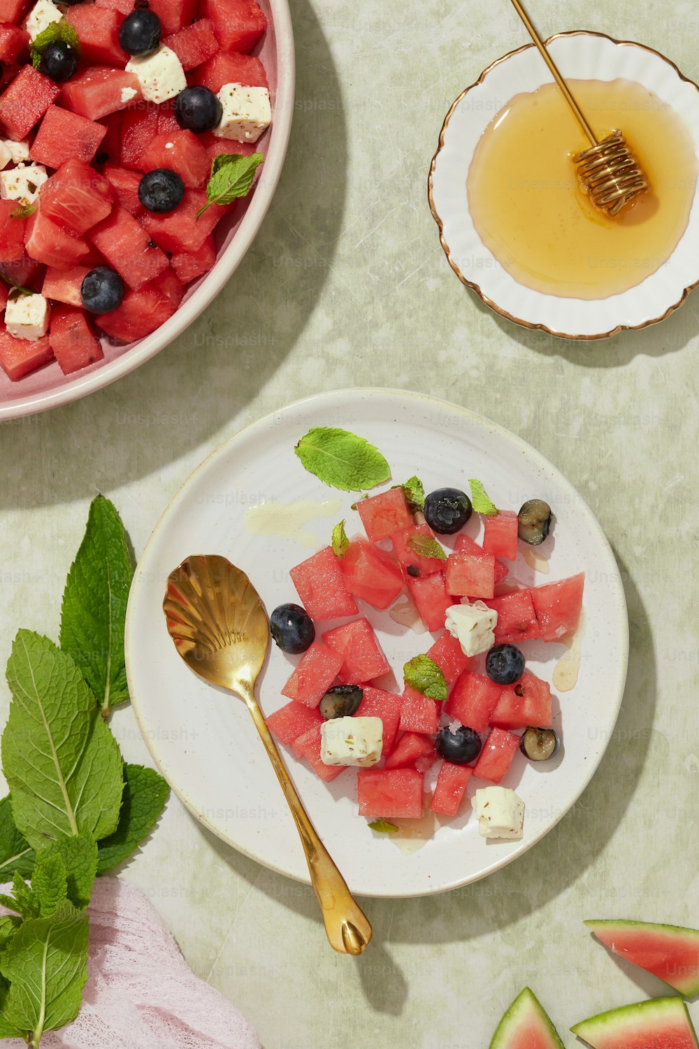 a plate of watermelon, blueberries, and feta cheese