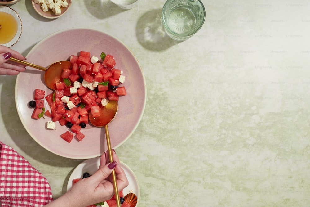 a plate of food with watermelon and cheese on it