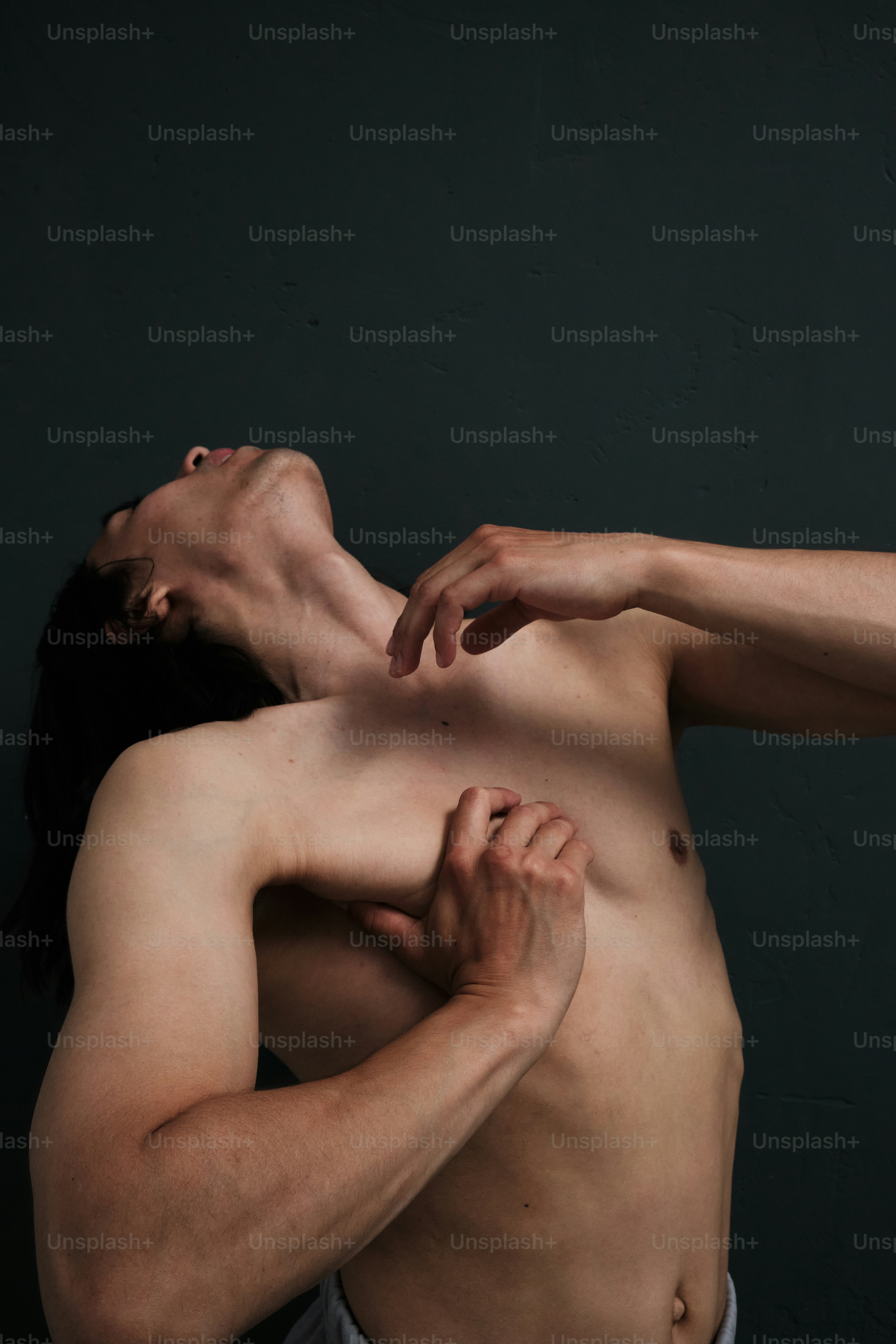 a man with no shirt is holding his shirt open