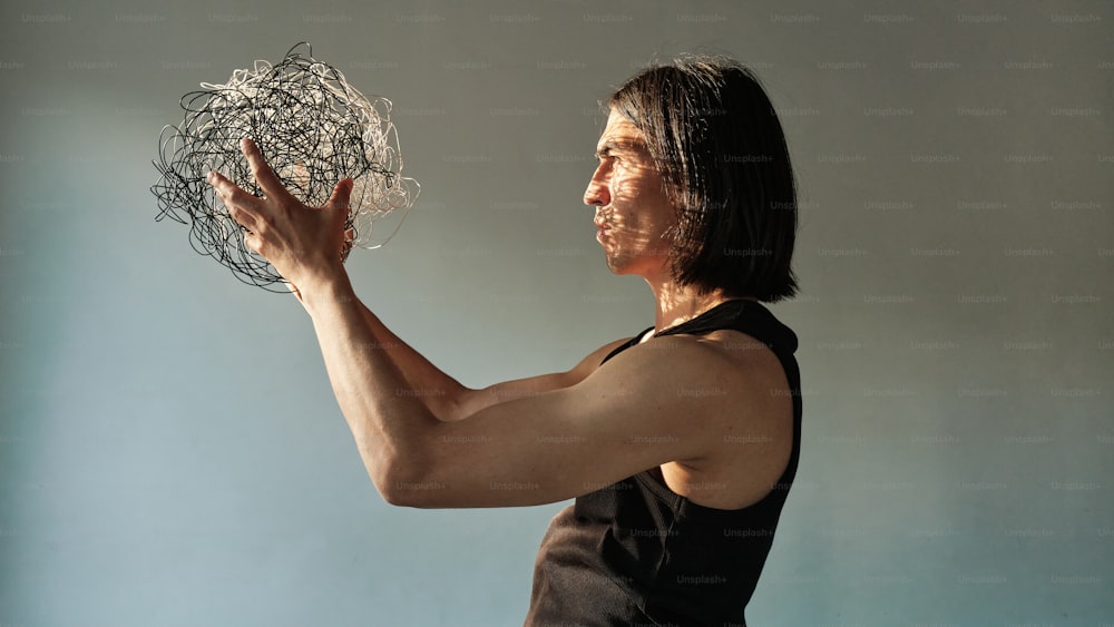 a woman holding a ball of string in her hands