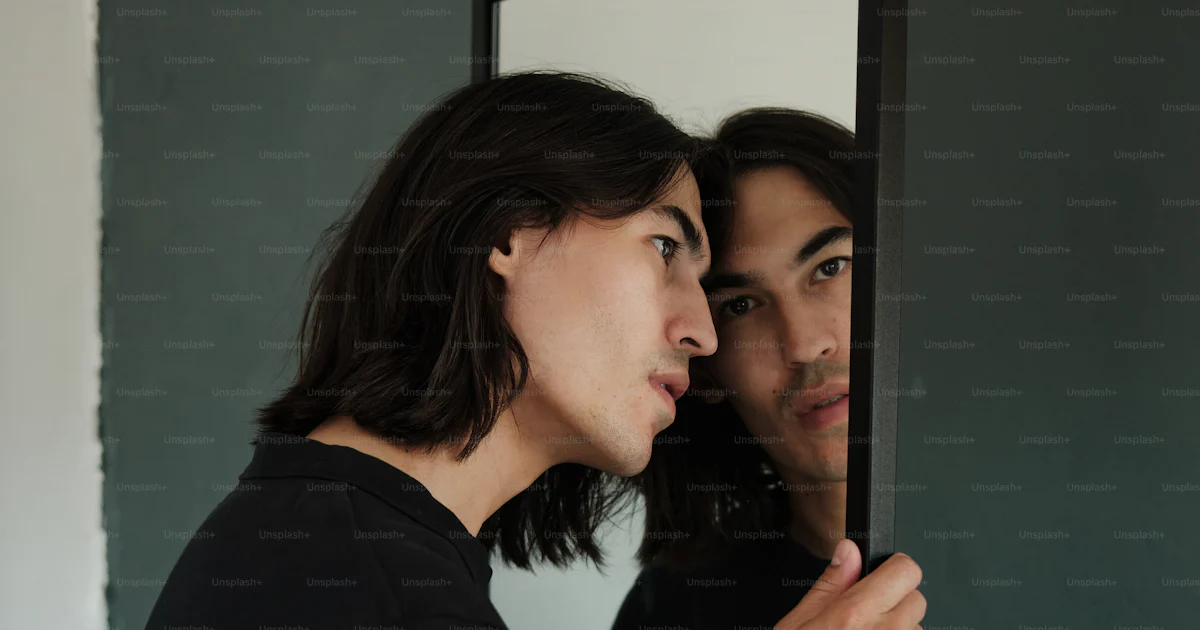 Person Looking Inreflection A man and a woman are looking at their reflection in a mirror photo ...