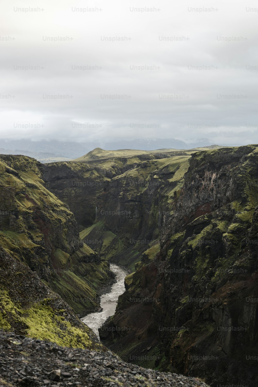 a river running through a valley surrounded by mountains