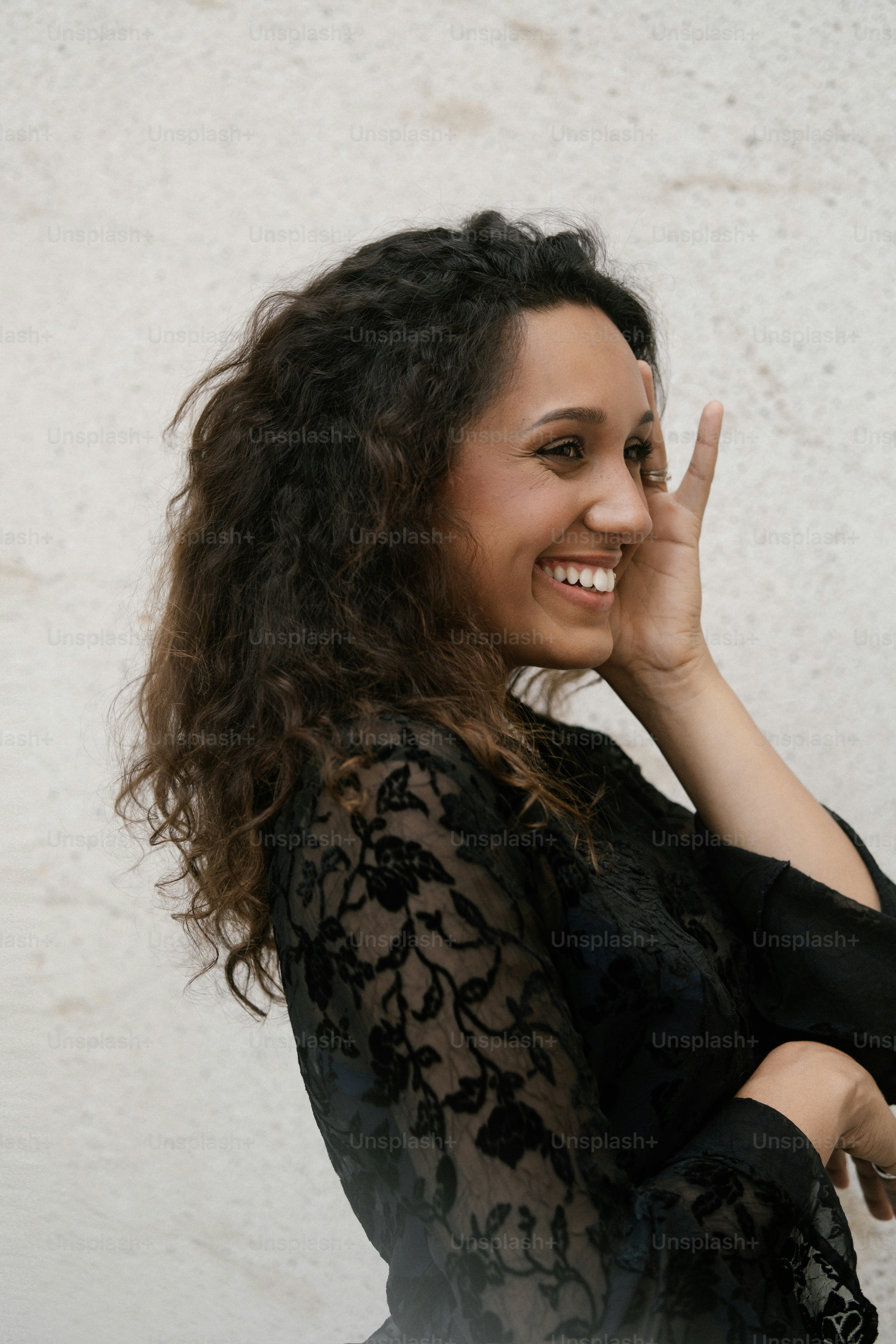 a woman is smiling and making a peace sign