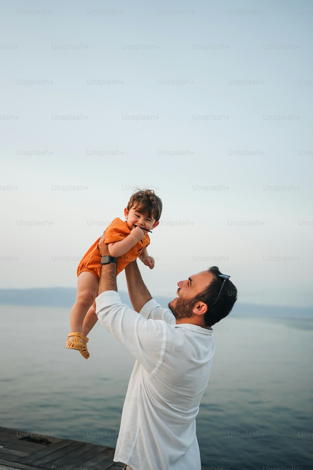 a man holding a baby up to his face
