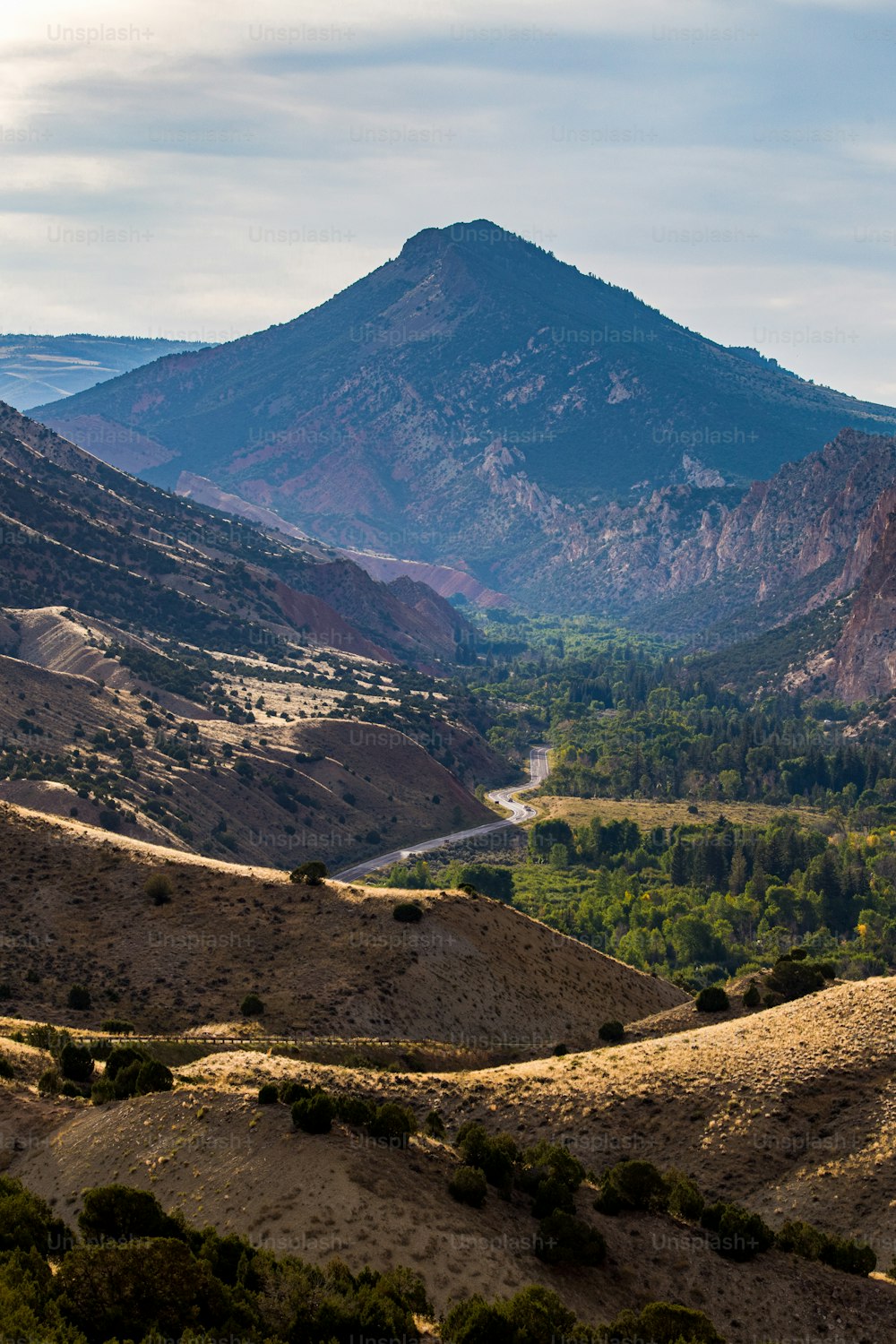 a view of a valley with mountains in the background