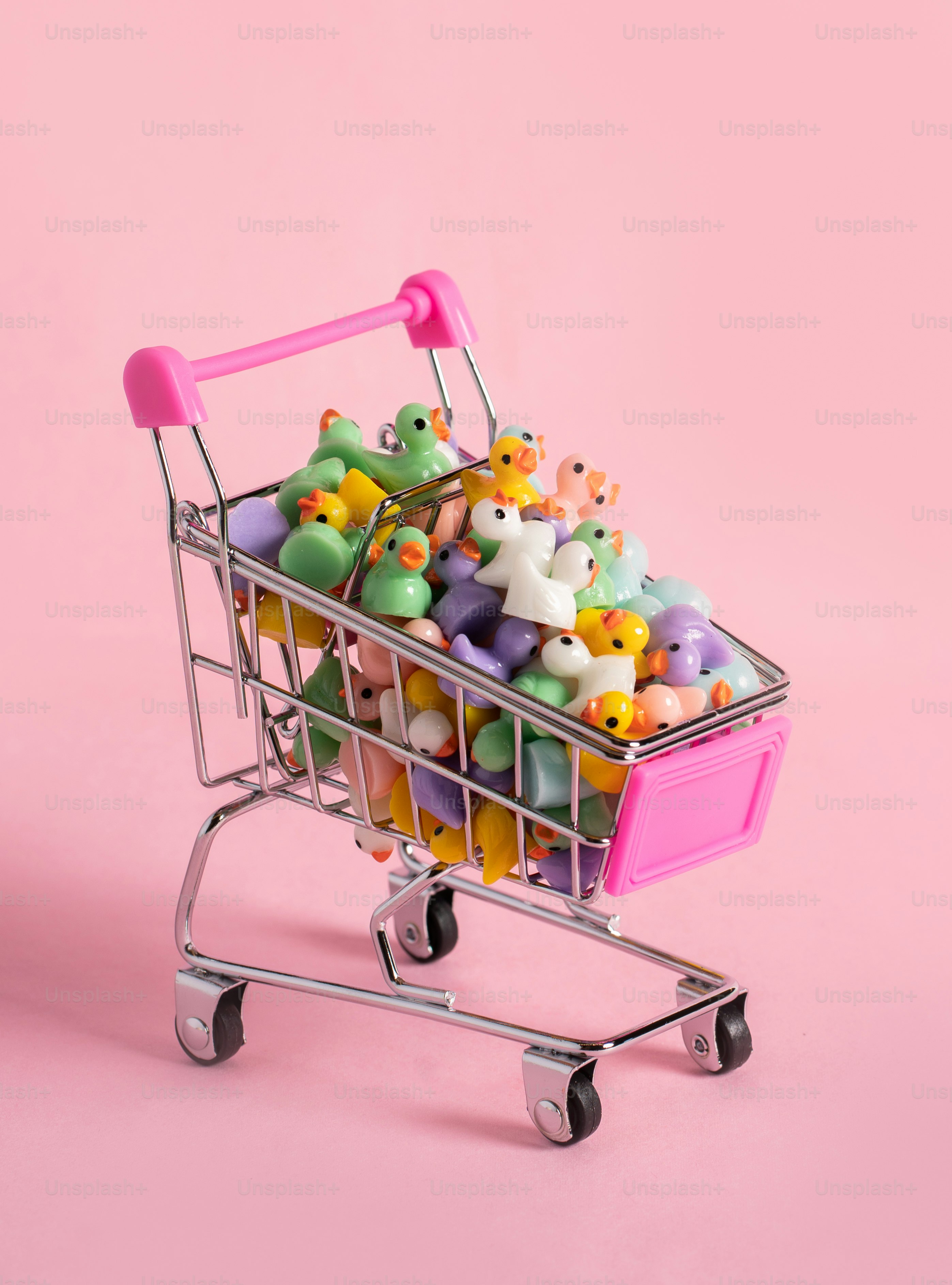 A mini shopping trolley filled with toy ducks