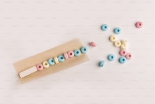 a pair of wooden beads sitting next to a piece of paper