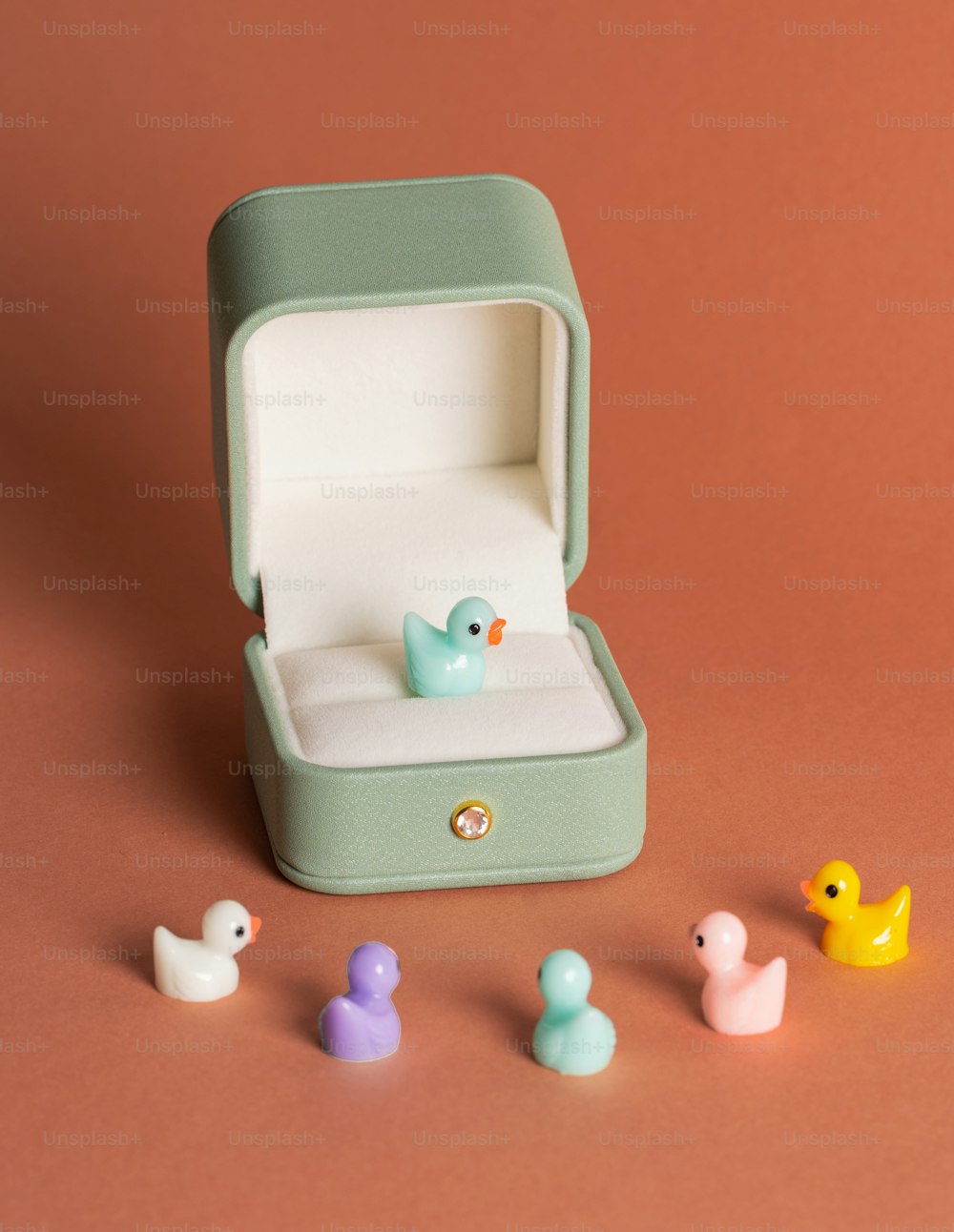 a small ring box with a rubber ducky in it