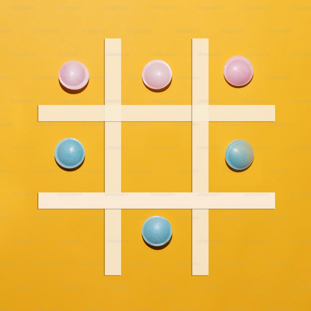 a game of tic - tac - toe on a yellow background