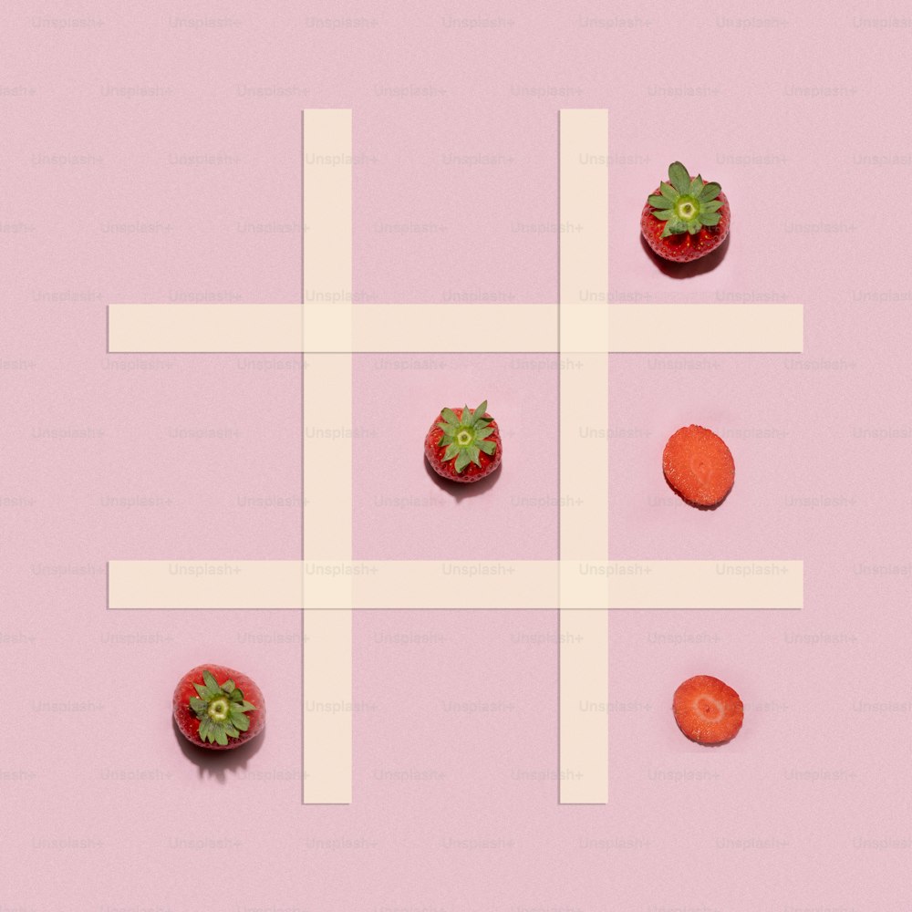 a cross made of fruits and vegetables on a pink background