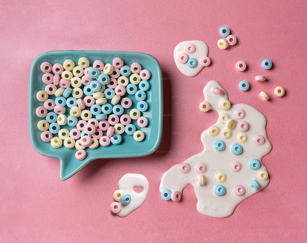 a bowl of beads next to a plate of cookies