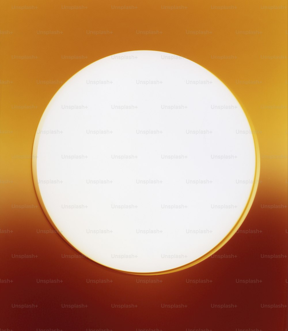 a close up of a light on a red and yellow background
