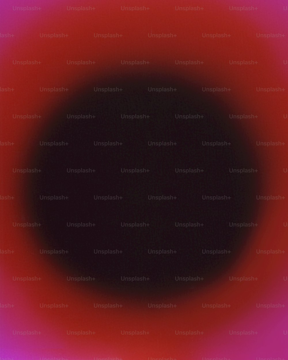 Un círculo negro con un centro rojo en el medio