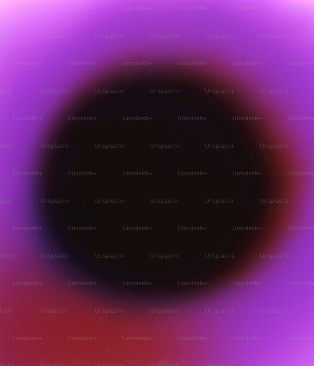 a blurry image of a black circle with a red center