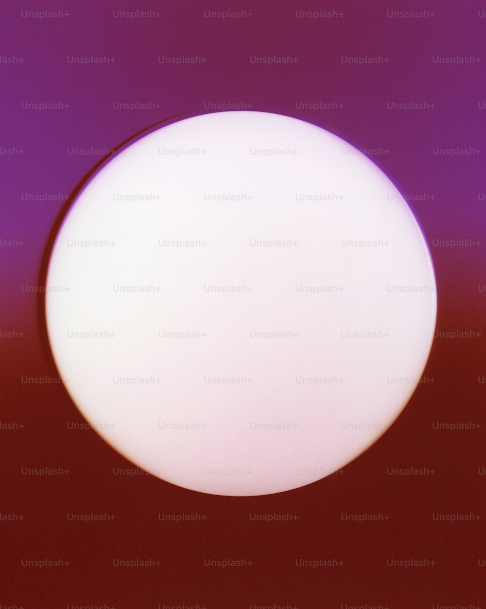 a white ball is in the middle of a purple background
