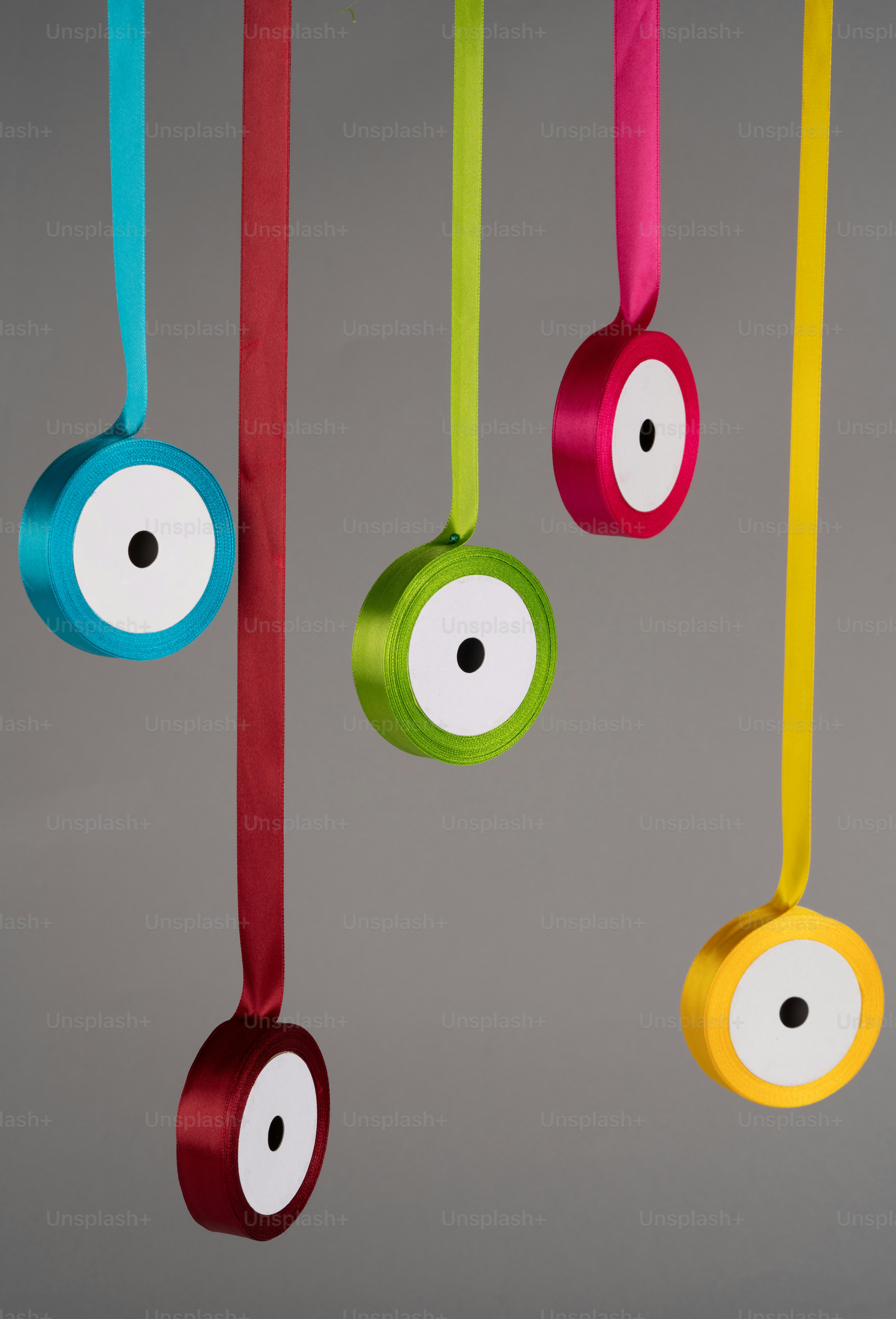 a group of colorful ribbons hanging from a ceiling