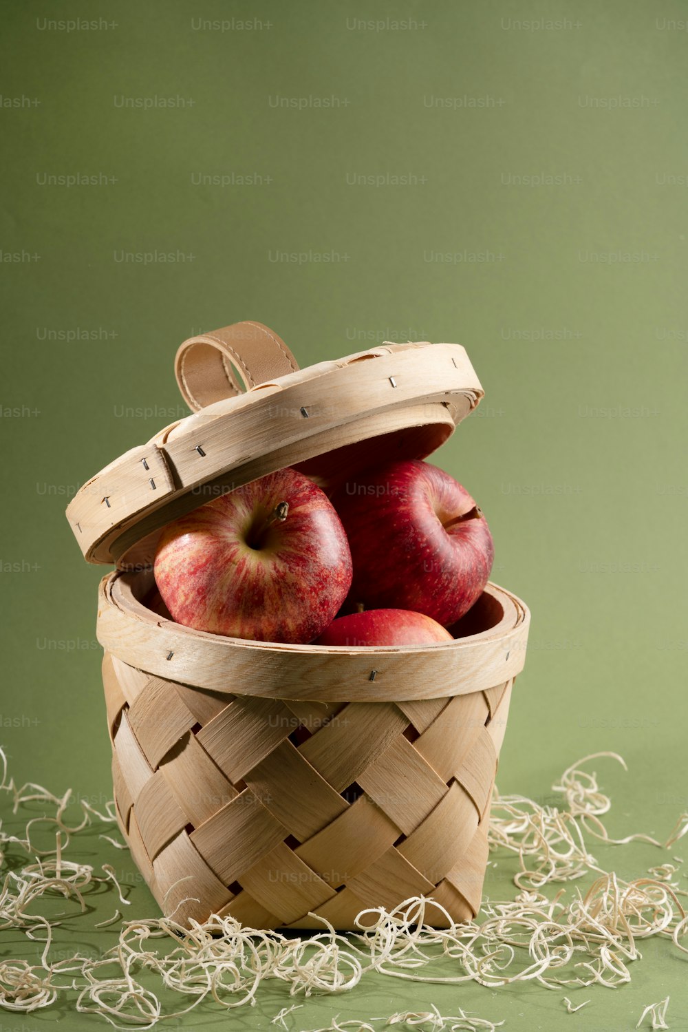 a basket filled with apples sitting on top of a table