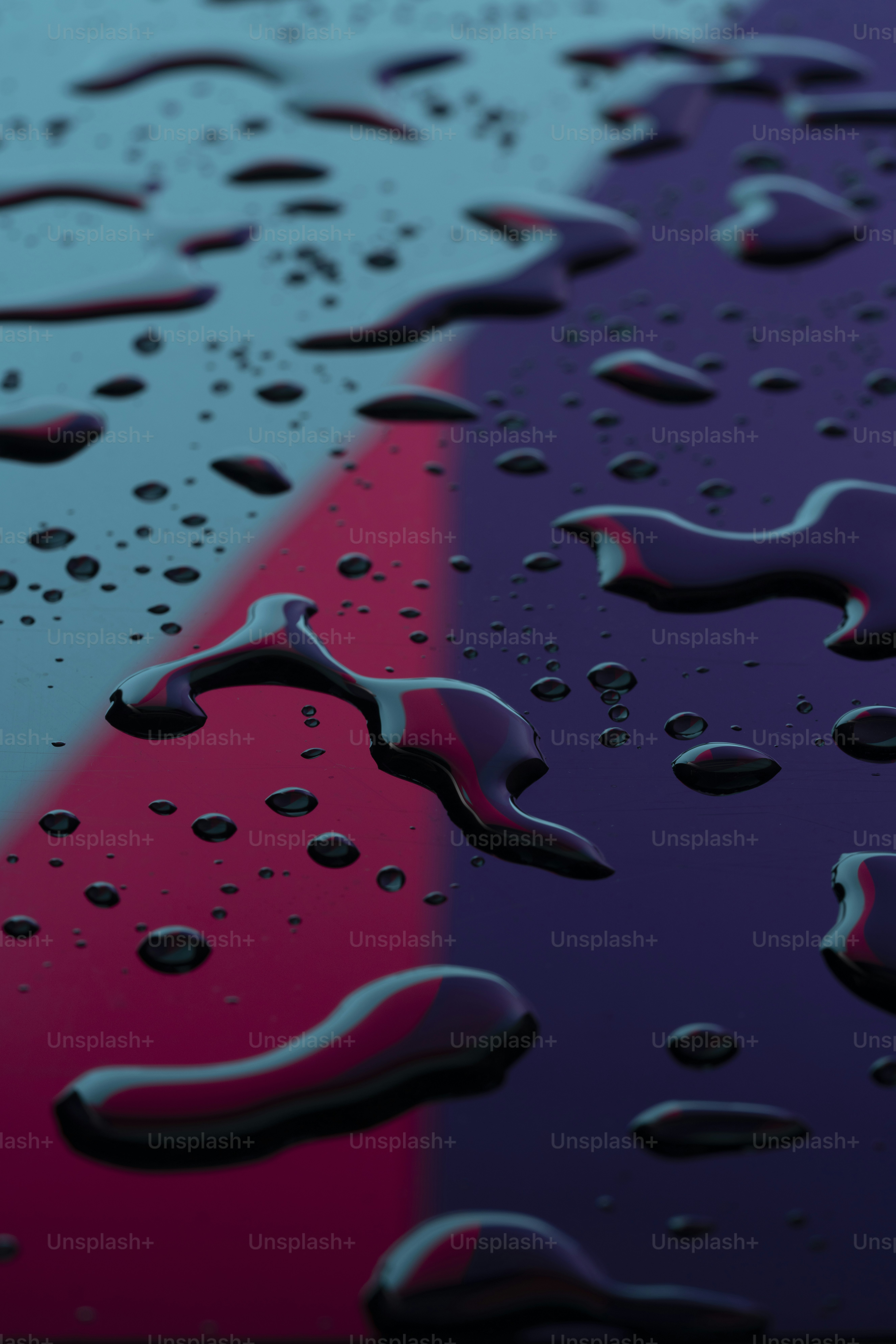 a close up of water droplets on a colorful surface