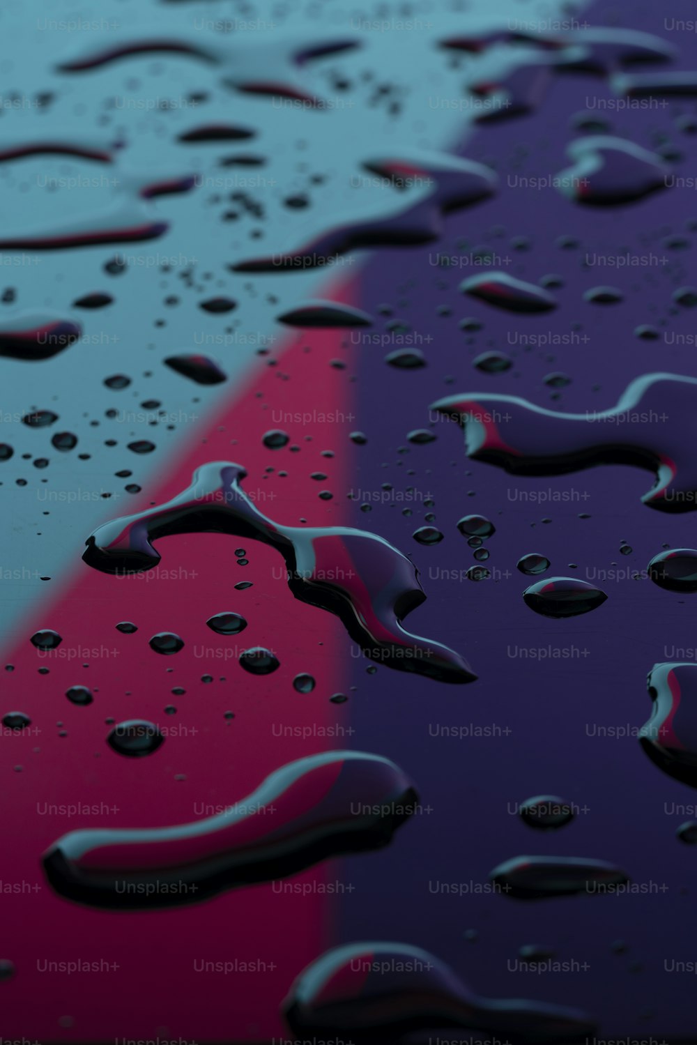 a close up of water droplets on a colorful surface