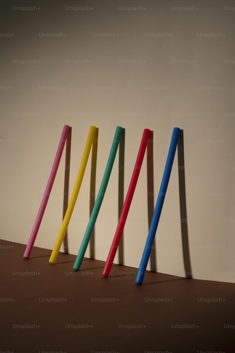 a row of colored toothbrushes sitting on top of a table