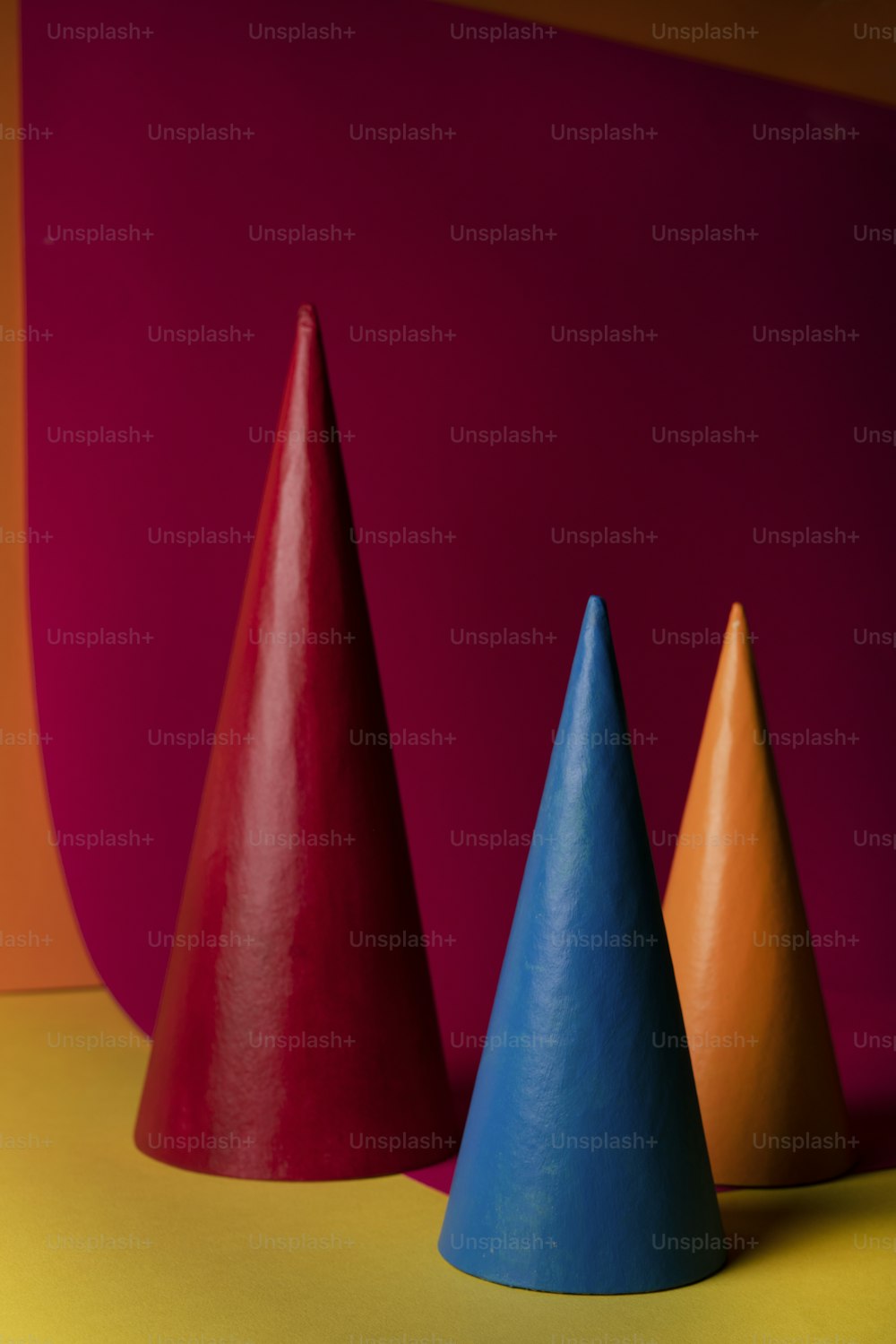 a group of three colorful cones sitting on top of a table