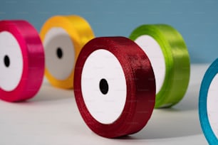 a row of different colored ribbons on a white surface