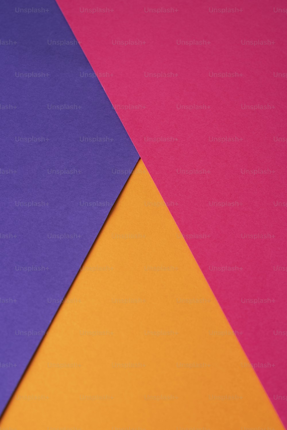 a close up of three different colored papers