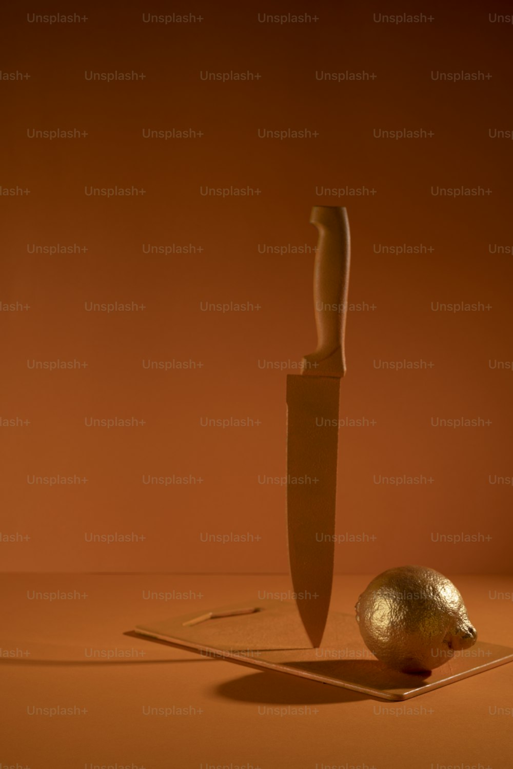 a knife and a golden egg on a table