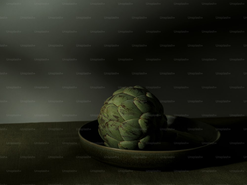an artichoke in a bowl on a table