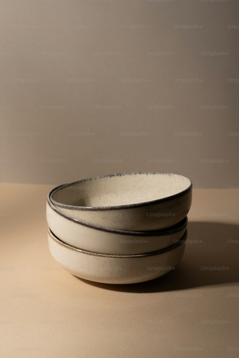 three white bowls sitting on top of a table