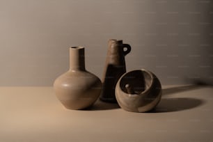 a couple of vases sitting on top of a table