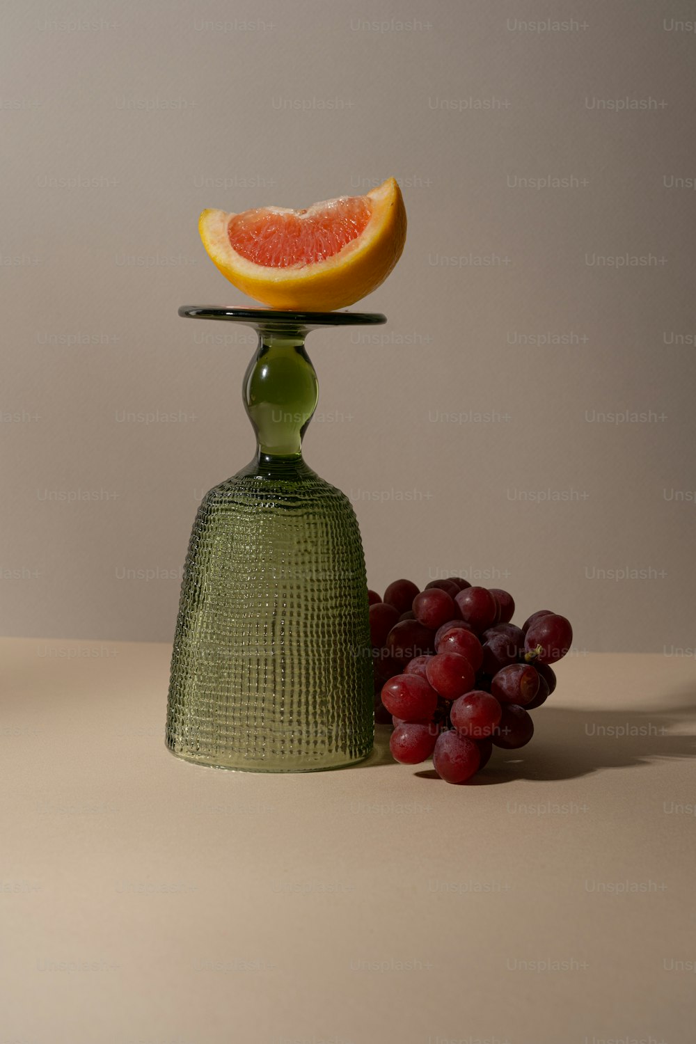 a grapefruit and a grapefruit on a glass stand