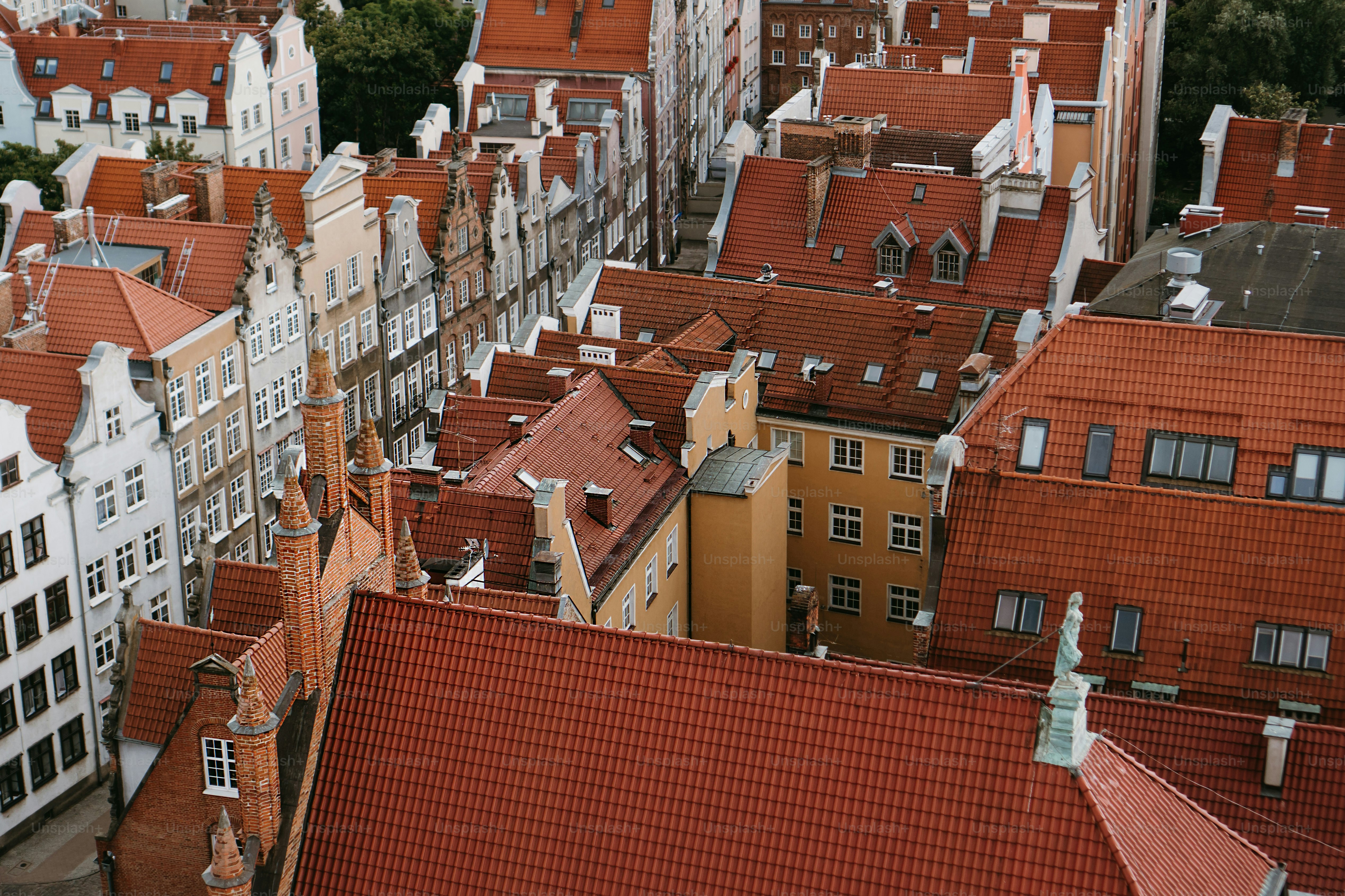 an aerial view of a city with red roofs